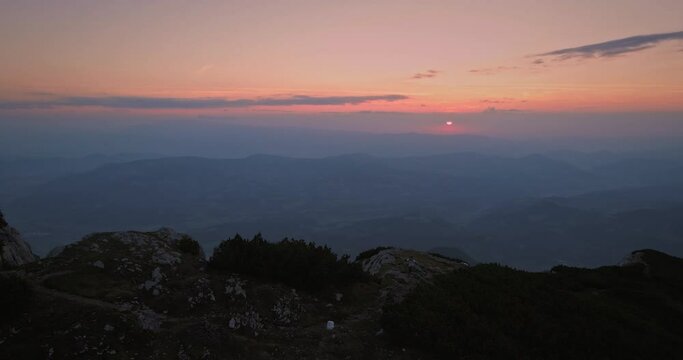 Drone shot of the end of the ridge of mountain Peca in early morning, sun is rising in the backgroud.
