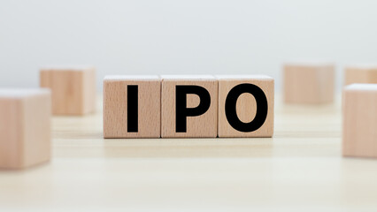 A wooden block with the word "IPO" or Initial Public Offering text on the wooden block. investment concept
