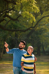 Young indian man with his father at park