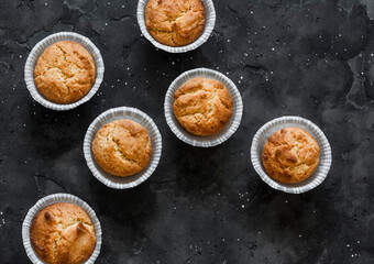 Simple cakes with peanuts on a dark background, top view
