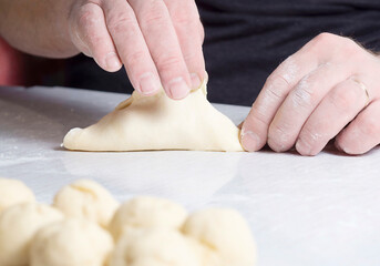 Human hands make pies. The concept of making homemade, tasty and healthy pastries.
