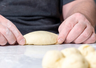 Human hands make pies. The concept of making homemade, tasty and healthy pastries.