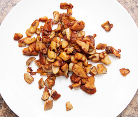 Fried mushrooms in a white plate on the table.