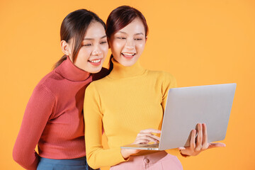 Fototapeta premium Image of two young Asian woman on background