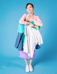 Image of young Asian businesswoman choosing clothes