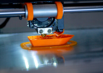3d printer printing a model close-up. The process of printing a model on a 3D printer made of...