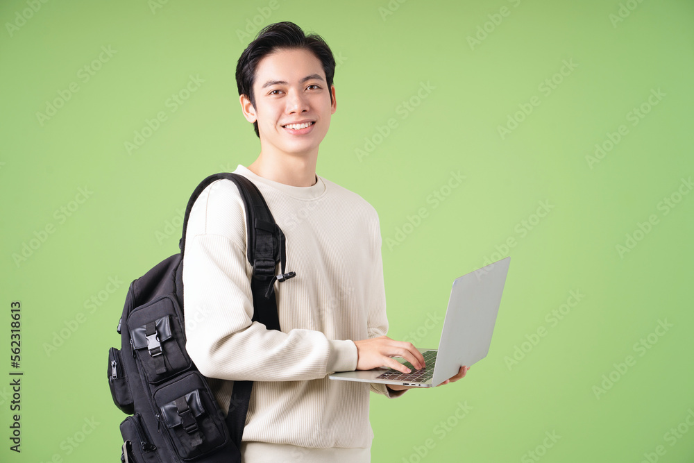 Wall mural image of young asian student on background