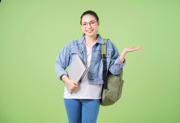 Photo of young Asian college girl on green background