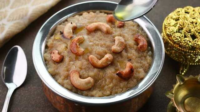 Pouring ghee on sakkarai pongal a traditional sweet based rice dish famous in South India.