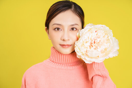 Photo of young Asian girl with flower