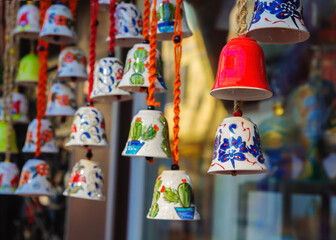 Ceramic bells painted with traditional Iznik ornaments. Turkish colorful souvenir in the street...