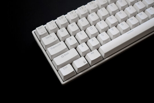 Close up white mechanical keyboard isolated on dark black background