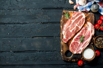 Raw pork steaks with aromatic and herbs and spices.