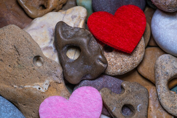 Obraz premium Sea pebbles of different colors with holes .