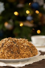 ant hill cake decorated with poppy seeds on a white plate. the concept of a festive tea party