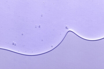 Cosmetic serum gel beauty on violet color background. Skincare beauty product with bubbles texture.