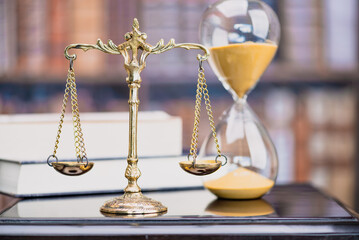 Legal office of lawyers, justice and law concept : Retro balance scale of justice on a desk in a courtroom, depicting giving fair and objective consideration to all evidence, without showing bias.