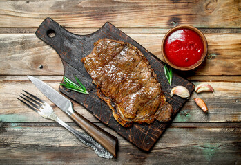 Grilled beef steak with sauce.