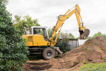 Fototapeta na wymiar A excavator is digging on outdoors in an industrial site. Excavation works