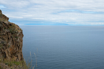 Fototapeta na wymiar Beautiful summer landscape of Baikal Lake on sunny day. View of the rocky cape