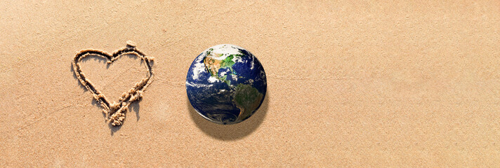 World earth globe,Heart Drawn in the Sand on a Beach.Love and take care of our Natural world with...