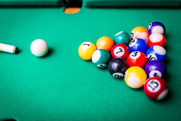 Cue aim billiard snooker pyramid on green table.Billiard balls on the green table with billiard cue, Snooker,Pool game.Top view.