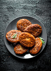 Cutlets on a plate with rosemary.