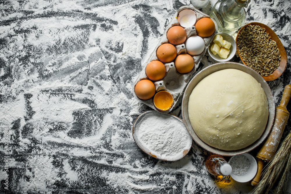 Sticker Dough with eggs, butter and grain in bowls.