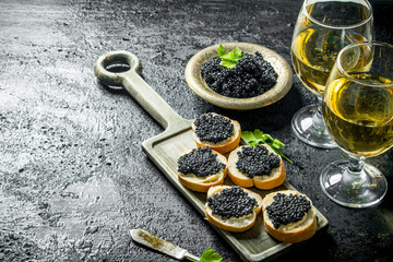 Sandwiches with black caviar and the wine.