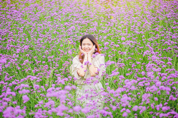 Attractive beautiful woman rise up her arms with happiness freedom in the middle of flower gardens