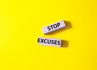 Stop excuses symbol. Concept words Stop excuses on wooden blocks. Beautiful yellow background. Business and Stop excuses concept. Copy space.