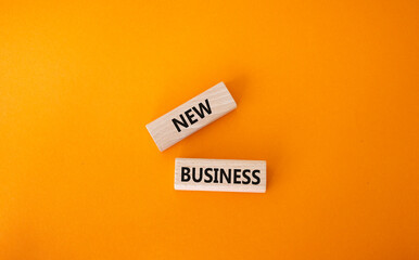 New business symbol. Concept words New business on wooden blocks. Beautiful orange background. Business and New business concept. Copy space.