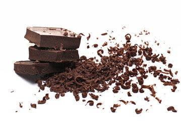 Chopped, milled dark chocolate pile with shavings isolated on white, side view