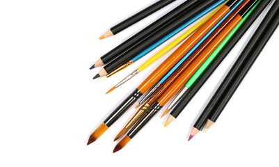 Paintbrushes and pencils isolated on white, top view