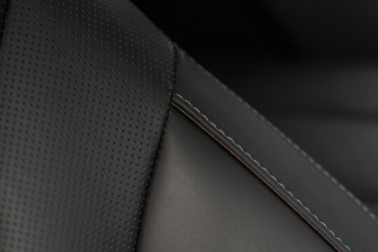 Part of leather car seat. Macro. Сar leather interior details. High angle view of modern car fabric seats.