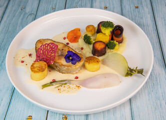 Recipe of cod steak, mashed potatoes and its farandole of vegetables, parsnip, turnip, broccoli, candied potato. High quality photo