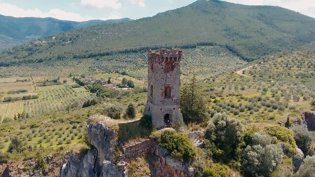 Caprona, Tuscany. Aerial view of famous medieval tower on the mountain top. Slow motion