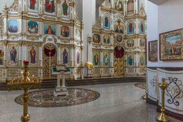 Fototapeta na wymiar Altar with icons and candles in an Orthodox Christian church. Faith, religion and culture.