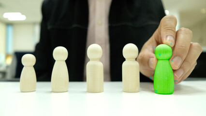 Human resources management and recruitment business build a team. Businessman hand-picking up a selected man from a group of businesspeople. Recruitment concept.