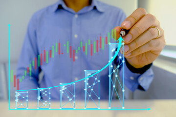 Businessmen hold a pen to draw growth graphs, business planning, and strategy, the progress of business and analyze financial and business investment data and set business growth goals on background.