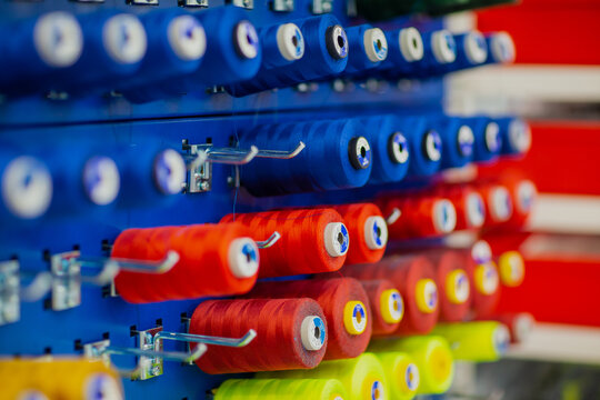 Blue and red spools of professional industrial thread in manufacturing clothing