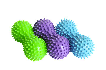 Fototapeta premium Purple, green and blue double or peanut spiky balls massager for yoga pilates or stretching and fascia pain. Sports equipment for fitness isolated on a white background. Concept of sports massage.