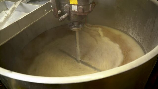 Mashing the grain and liquor in the mash tun where brewing beer