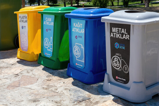 Beldivi, Turkey - July 28, 2022: Four garbage bins for different sorts of recyclable waste labeled in Turkish (plastic, glass etc). Beldivi Beach (Antalya). Environment, ecology or city life concept