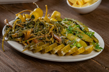 pickles from different vegetables on a plate, selective focus