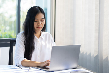 Serious businesswoman in the office is tired from overwork and headaches from stress.