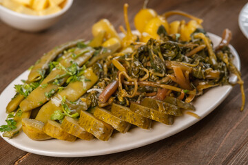 pickles from different vegetables on a plate, selective focus