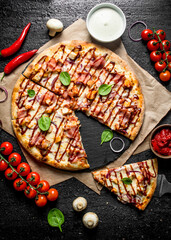 Barbecue pizza with spinach leaves, cherry tomatoes and cheese sauce.