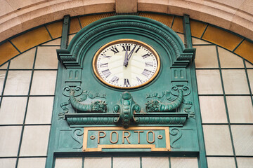 Porto, Portugal - 25.12.2022: Vintage station clock in Sao Bento Train Station, famous for its azulejo tiled walls. High quality photo