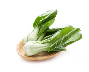 pile of baby bok choy or pak choy in wood plate isolated on white background. heap of bok choy isolated. green bok choy isolated                                                    